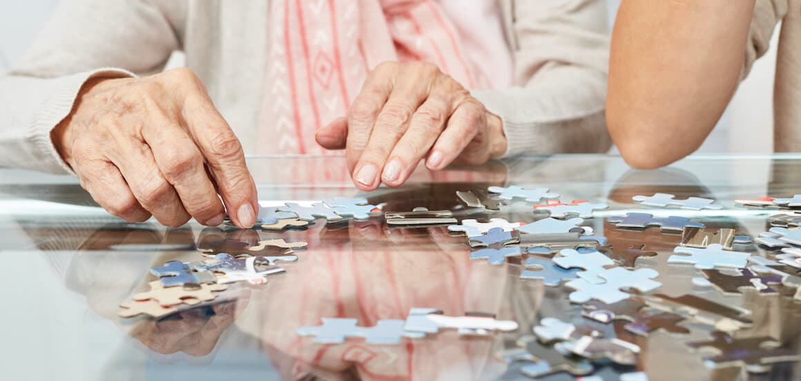 Senior woman participates in a mind-engaging activity.